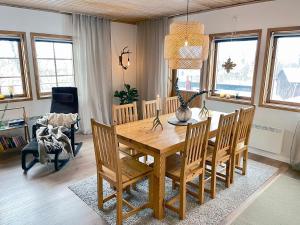 a dining room with a wooden table and chairs at Stugan i Åsvallen in Tänndalen