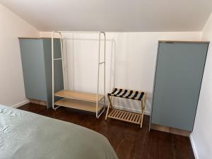 a bedroom with a bed and two glass shelves at Le Trente 9 in Neufchâteau