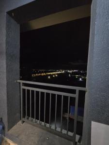 a balcony with a view of the city at night at Sumqayıt, Mərkəzdə mənzil in Sumqayyt
