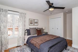 a bedroom with a bed and a ceiling fan at Modern 3BR Getaway-Stylish Ames in Ames