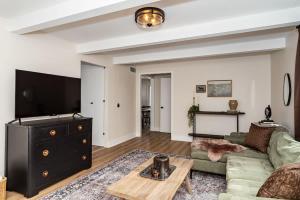 a living room with a couch and a tv at Modern 3BR Getaway-Stylish Ames in Ames