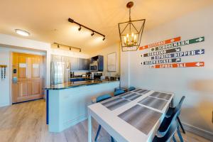a kitchen and dining room with a table and chairs at Silvermill Lodge 8285 in Keystone
