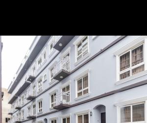 a white building with balconies on the side of it at Bethel in Lagos