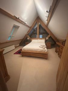 a room with a bed in a attic at Welsh Apple Barn in Chepstow