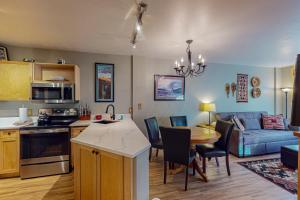a kitchen and living room with a couch and a table at Silvermill Lodge 8202 in Keystone
