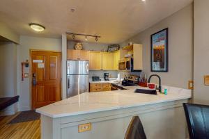 a kitchen with a large island in the middle at Silvermill Lodge 8202 in Keystone