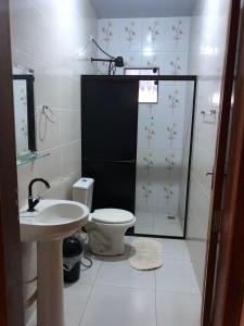 un bagno con wc, lavandino e doccia di Pousada e Marina Pesca Tucuna a Presidente Epitácio