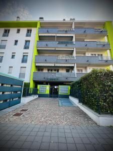 a large building with a parking lot in front of it at Maison Du Pic - Rho Fiera in Pero