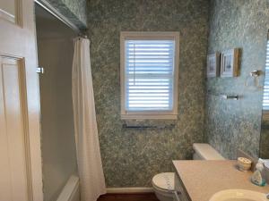 a bathroom with a sink and a toilet and a window at Neutral Ground in Edisto Island +17 photos