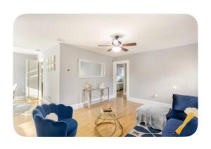 a living room with blue chairs and a ceiling fan at Seashell & Sunshine Lodge in St Petersburg +12 photos