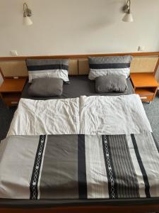 a bed in a room with two twin beds at Park & Stay Central in Piešťany