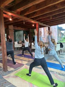 a group of people doing yoga in a room at Centro Holístico Kinam in Amecameca de Juárez