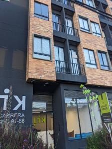 a tall brick building with a store front at Encantador apartaestudio Charming studio apartment in Bogotá