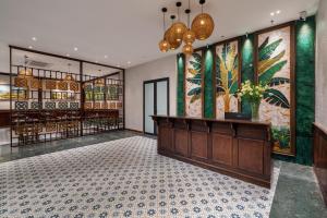 a lobby of a building with paintings on the walls at The Greenary Garden in Ninh Binh +20 photos