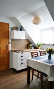 a kitchen with a table and a counter top at Lilla Vendégház in Balatonudvari