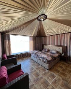 a bedroom with a bed and a couch in a room at Rum ahmad in Wadi Rum