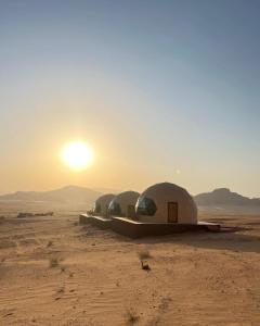 a group of tents in the desert at sunset at Rum ahmad in Wadi Rum