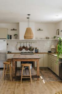 a kitchen with a wooden table and a refrigerator at Berry's Farm in Vosburg