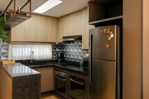eine Küche mit einem Kühlschrank aus Edelstahl in der Unterkunft Flat de luxo no Monte Castelo - by Haus in Bezerros