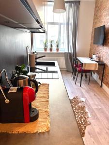 a living room with a table and a dining room at Apartment Matīsa in Rīga