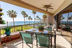 a balcony with a table and chairs and the ocean at Sonoran Spa E204 in Puerto Peñasco