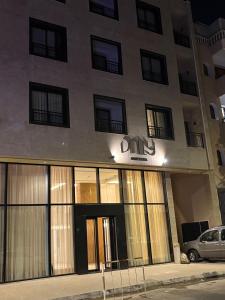 a building with a car parked in front of it at Dally Apart Hotel in Rabat