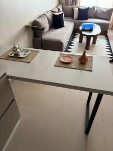 a living room with a table and a couch at Dally Apart Hotel in Rabat