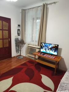a living room with a table with a laptop on it at Erik Apartments in Budapest