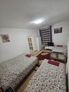 a room with three beds in a room at Erik Apartments in Budapest