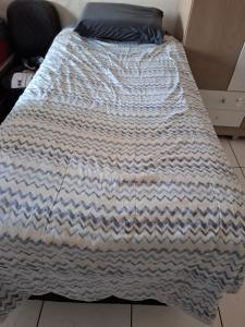 a bed with a blanket on top of it at Casa Próximo da UFPA - COP30 in Belém +20 photos