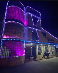 a building decorated with purple and blue lights at Club La Riviera in Ipiales