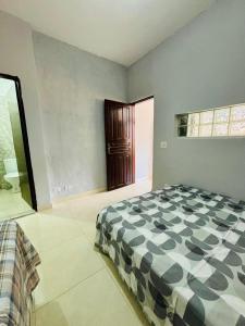 a bedroom with a bed and a large window at Chalés em Ilhabela 01 in Ilhabela