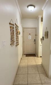 einen Flur mit weißer Tür und Fliesenboden in der Unterkunft Family Friendly Beach Condo with Pool in South Padre Island + 9 Fotos