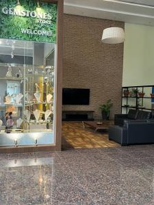 a living room with a store window with a couch at Flat Executivo Intercity Manaus - Moderno e Aconchegante in Manaus +32 photos