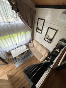 an overhead view of a living room with a couch and a table at Recele Tiny Nest in Ilva Mare +44 photos