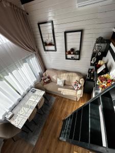 a living room with a couch and a table at Recele Tiny Nest in Ilva Mare