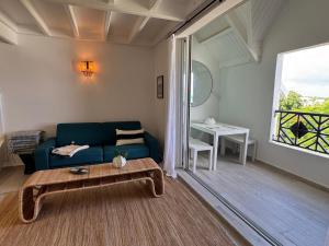 a living room with a blue couch and a table at Mare Gaillard in Mare Gaillard