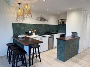 a kitchen with a counter and a table and chairs at Mare Gaillard in Mare Gaillard