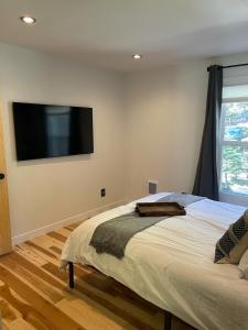 a bedroom with a bed and a flat screen tv on the wall at Blue Bear - Perfect Mountain Getaway in Idaho Springs