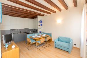 ein Wohnzimmer mit einem Tisch und einem blauen Stuhl in der Unterkunft Venice Appartament Salini - Near the Biennale in Venedig + 18 Fotos