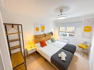 a bedroom with a bed with a teddy bear on it at El Ebro del Pilar - Turistea in Zaragoza