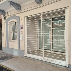 a window with blinds on the side of a building at RESIDENZA CORSO DALMAZIA in Civitanova Marche