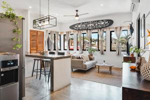 a kitchen and living room with a couch and a table at Downtown Casa Conchita Guest Suites in Sayulita