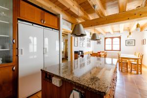 a kitchen and dining room with a large counter top at Casa Tadeguaz in Fago +39 photos
