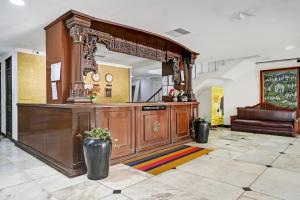a lobby with a large wooden counter in a room at Townhouse OAK Hotel Belsons Taj Mahal in Hyderabad
