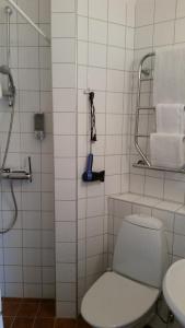 a bathroom with a toilet and a shower with towels at Lilla Hotellet in Lund +80 photos