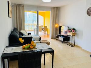 a living room with a table with fruit on it at Bright Retreat with Lush Outdoor Space in Palm-Mar