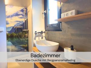 a bathroom with a white sink and a window at TinyHousebeiDresden spektakuläres winziges Häuschen auf Stelzen im Pferdeteich, Kaminofen, umlaufende Terrasse - Nähe Sächsische Schweiz - Von Juni - September Mindestmietzeit 1 Woche Sa-Sa in Großharthau