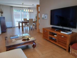 a living room with a large flat screen tv at Casa en Valencia, piscina, cerca de golf, playas, moto Gp in Valencia