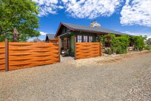 a house with a wooden fence in front of it at Rockhouse Retreat 1-br Housetimeless Dcortrails in Granite Dells